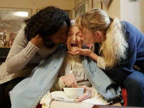 Emma Morano, 117 years hold, is kissed by her caretakers Malgorzat Ceglinska, right, and Yamilec Vergara, in the day of her birthday in Verbania, Italy, Tuesday, Nov. 29, 2016.