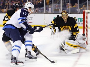 Bruins goalie Tuukka Rask  makes a save on a shot by the Winnipeg Jets' Adam Lowry during their game in Boston on Saturday night.