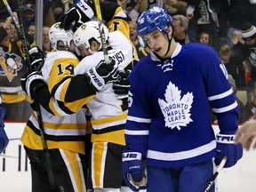 Chris Kunitz celebrates his goal with Penguins teammates as Toronto Maple Leafs forward Mitch Marner skates back to his bench on Nov. 12.