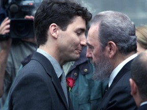 A grieving Justin Trudeau is consoled by Cuban President Fidel Castro in front of Notre Dame Church prior to the funeral of Pierre Trudeau.