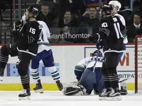 Cal Clutterbuck, left, and Alan Quine of the New York Islanders celebrate what proved to be the game-winning goal in NHL action Monday night in Brooklyn, N.Y.  In winning 4-2, the Islanders handed the Canucks their ninth straight setback.