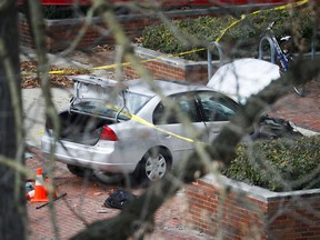 A car inside a police line sits on the sidewalk as authorities respond to an attack on campus at Ohio State University, Monday, Nov. 28, 2016, in Columbus, Ohio