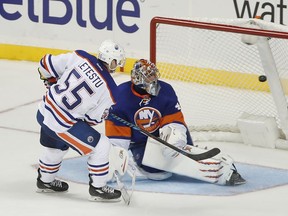 Mark Letestu  of the Edmonton Oilers scores the winning goal in a shootout against New York Islanders goalie Jaroslav Halak during their game, Saturday night in New York. The Oilers won 4-3.