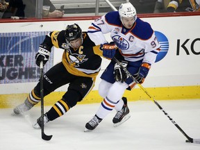 Edmonton Oilers' Connor McDavid, right, and the Penguins' Sidney Crosby compete for the puck during the first period of their game in Pittsburgh on Tuesday night.