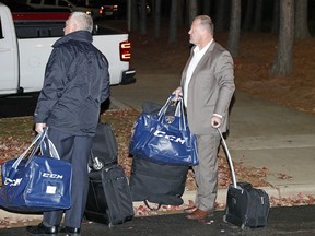 Gerard Gallant, right, former Florida Panthers head coach, waits for a cab after being relieved of his duties in Raleigh, N.C. on Nov. 27.