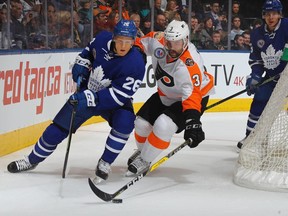 Philadelphia Flyers defenceman Radko Gudas (right) pokes the puck from Toronto Maple Leafs winger Nikita Soshnikov on Nov. 11.