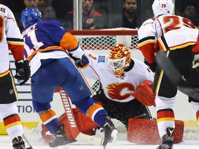 Goaltender Brian Elliott of the Calgary Flames denies the scoring attempt of Shane Prince of the New York Islanders during NHL action Monday night at the Barclays Centre in Brooklyn, N.Y.