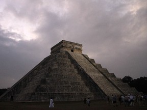 In this Dec. 21, 2012 file photo, people gather in front of the Kukulkan temple in Chichen Itza, Mexico. Mexican experts said Wednesday, Nov. 16, 2016 they have discovered what may be the original structure at the pyramid of Kukulkan at the Mayan ruins of Chichen Itza.