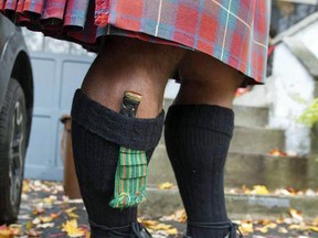 Professional piper Jeff McCarthy wears a  a sgian-dubh (pronounced skin-do) in his sock at home in Montreal, Thursday November 3, 2016.