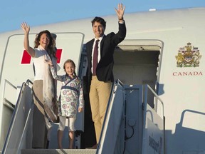 Canadian Prime Minister Justin Trudeau, his wife Sophie Gregoire, and daughter Ella-Grace wave as they board a government plane in Ottawa, Monday August 29, 2016