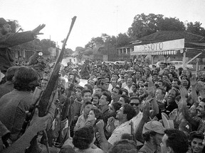 In this Jan. 7, 1959, photo, rebel leader Fidel Castro, far left, addresses a crowd in Colon, Cuba as he and his caravan make a stop on their way to the capital.