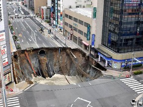 A massive shinkhole is created in the middle of the business district in Fukuoka, southern Japan Tuesday, Nov. 8, 2016.