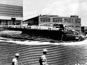 In this July 9, 1960 file photo the 278-foot (82 meters) long nuclear powered attack submarine USS Thresher, a first in its class boat, is launched bow-first at the Portsmouth Navy Yard in Kittery, Maine.