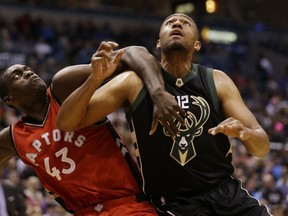 Toronto Raptors' Pascal Siakam and the Bucks' Jabari Parker fight for position during the second half of their game Friday night in Milwaukee.