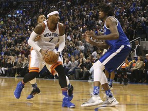 Lucas Nogueira of the Raptors, right, guards against New York Knicks' Carmelo Anthony in the fourth quarter of their game at the Air Canada Centre in Toronto on Saturday night.