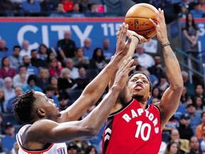 Toronto Raptors guard DeMar DeRozan goes up for a shot as Oklahoma City Thunder forward Jerami Grant defends during the first half of an NBA game in Oklahoma City on Wednesday,