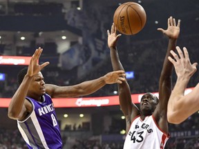 Rudy Gay, left, of the Sacramento Kings battles Pascal Siakam of the Toronto Raptors for a loose ball during NBA action Sunday in Toronto. Gay had 23 points in the Kings' 96-91 victory.
