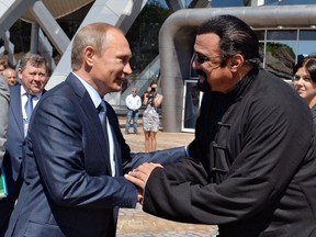 In this Sept. 4, 2015 file photo, Russian President Vladimir Putin, left, and U.S. actor Steven Seagal shake hands after visiting an oceanarium built on Russky Island, in the Russian Far Eastern port of Vladivostok.