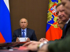 Russian President Vladimir Putin chairs a meeting on military issues in the Bocharov Ruchei residence in the Black Sea resort of Sochi, Russia, Friday, Nov. 18, 2016.