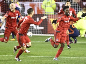 Toronto FC forward Tosaint Ricketts (right) celebrates with teammates Will Johnson (centre) and Michael Bradley after scoring against New York City FC in the first leg of their MLS Eastern Conference semi-final on Oct. 30.