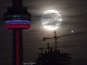 The super perigee full moon sets behind the CN tower in Toronto on Monday November 14, 2016