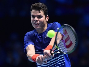 Milos Raonic returns a shot to Novak Djokovic during their singles round robin match at the ATP finals on Nov. 15.