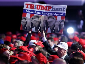 A Donald Trump supporter holds a sign aloft at an election night rally at the New York Hilton on Nov. 8, 2016.