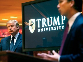 Donald Trump listens as he is introduced  at a news conference in New York where he announced the establishment of Trump University in 2005.