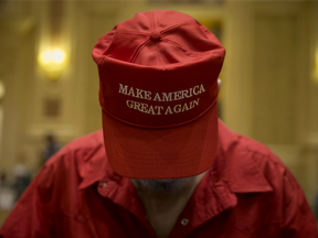 An attendee wears a "Make America Great Again" hat before the start of a campaign rally for Donald Trump, 2016 Republican presidential nominee, at the Venetian Hotel and Casino in Las Vegas, Nevada, U.S., on Saturday, Oct. 30, 2016.