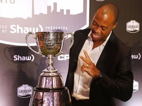 Holding up two fingers for the number of cups he's won, Ottawa Redblacks QB Henry Burris looks at but will not touch the Grey Cup at Media Day in Toronto on Thursday November 24, 2016.