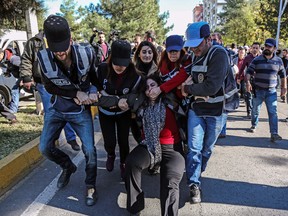 Turkish police officers detain Sabahat Tuncel (C), former Pro Kurdish People's Democracy Party member of the Parliament on November 4, 2016 at Diyarbakir courthouse during a demonstration.