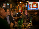 Russian politics-watchers react as the TV in a Moscow bar shows Donald Trump headed for victory on U.S. Election Day.