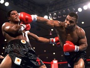 In this Nov. 22, 1986, photo, Mike Tyson, right, delivers a powerful blow to Trevor Berbick in the second round in Las Vegas.