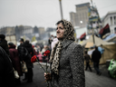 A Ukrainian woman stands in the central square of Kyiv on March 1,2014, as Russian forces began to overthrow Ukrainian control of Crimea, an event condemned by most Western powers