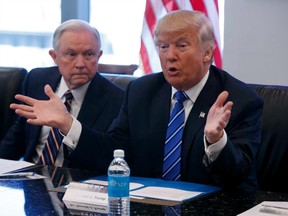 Sen. Jeff Sessions, R-Ala., left, looks on as Republican presidential candidate Donald Trump speaks during a national security meeting with advisors at Trump Tower in New York on Oct. 7, 2016. His new attorney general once lost a job over alleged racism against blacks. His new national-security adviser not only blasts Muslims, but has also reportedly been paid recently by the governments of Russia and Turkey. Donald Trump made one thing clear Friday: He will appoint loyalists to top positions - controversy be damned.