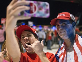 Attendees take a selfie photograph during a campaign rally in Moon Township, Pennsylvania