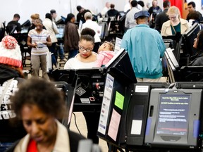 Early voters use electronic ballot casting machines in Columbus, Ohio, on Nov. 7.