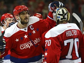 Alex Ovechkin, left, of the Washington Capitals congratulates winning goaltender Braden Holtby following a 4-3 overtime win over the Winnipeg Jets in Thursday NHL action in Washington. Ovechkin had two goals including the game winner.