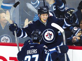 Jets rookie forward Patrik Laine celebrates his third goal of the game against the Dallas Stars with winger Nikolaj Ehlers during their game in Winnipeg on Tuesday night.