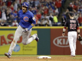 Chicago Cubs' Addison Russell celebrates after his grand slam homer against the  Indians during the third inning of Game 6 of the World Series on Tuesday night in Cleveland.