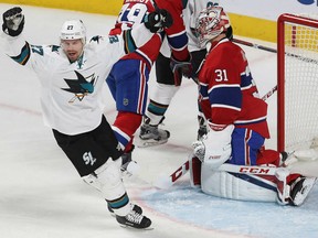 San Jose Sharks' Joonas Donskoi, celebrates a goal by teammate David Schlemko,as he skates by Montreal Canadiens goalie Carey Price, during the first period in Montreal on Friday.