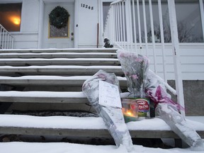 A small memorial sits outside a home in Edmonton Saturday Dec. 24. Rachael Longridge, 21, was found dead at a home Dec. 23, and her mother now faces second-degree murder charges.