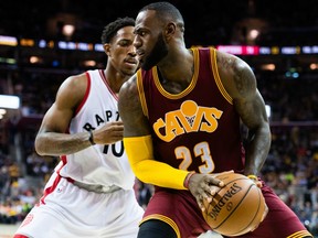 Toronto Raptors guard DeMar DeRozan (left) guards Cleveland Cavaliers forward LeBron James on Nov. 15.