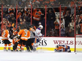 Michael Raffl #12 of the Philadelphia Flyers is mobbed by teammates after scoring the go-ahead goal against the Edmonton Oilers during the Flyers 6-5 win at Wells Fargo Center on December 8, 2016 in Philadelphia, Pennsylvania.