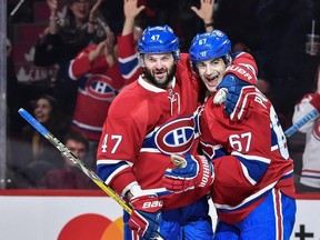 Alexander Radulov, left, celebrates the third goal scored by Max Pacioretty during Saturday's 10-1 victory by the Montreal Canadiens over the Colorado Avalanche on Dec. 10, 2016.