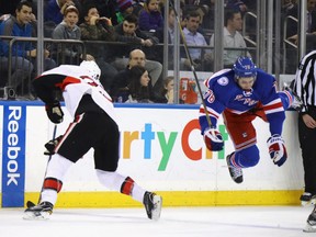 Chris Neil of the Ottawa Senators upends Brady Skjei of the New York Rangers during the first period at Madison Square Garden on Yuesday in New York City. The Rangers won 4-3.