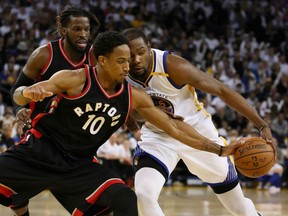 DeMar DeRozan of the Toronto Raptors tries to steal the ball from Kevin Durant of the Golden State Warriors at Oracle Arena in Oakland, Calif., on Wednesday night.