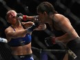 Amanda Nunes of Brazil punches Ronda Rousey in their UFC women's bantamweight championship bout during the UFC 207 event in Las Vegas on Friday night.