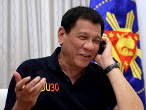 President Rodrigo Duterte gesturing as he talks on the phone at Legaspi Suites in Davao City