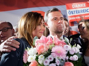 Austrian far-right candidate Norbert Hofer receives flowers next to his wife Verena after Austria's Presidential elections in Vienna on December 4, 2016